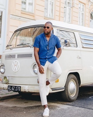 Blue Short Sleeve Shirt Outfits For Men: A blue short sleeve shirt and white chinos are a combination that every dapper guy should have in his off-duty fashion mix. Finish with white canvas low top sneakers and you're all done and looking smashing.