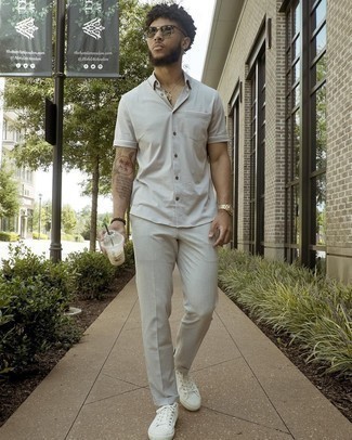 Tan Short Sleeve Shirt Outfits For Men: This combination of a tan short sleeve shirt and beige chinos is simple, dapper and super easy to copy. All you need is a great pair of white canvas low top sneakers.