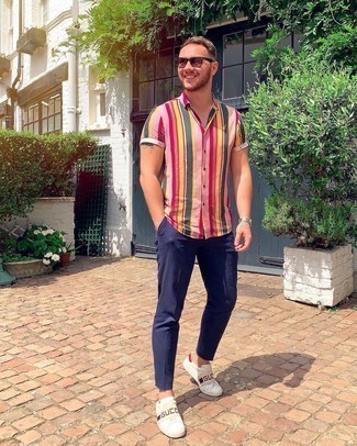 Multi colored Vertical Striped Short Sleeve Shirt Outfits For Men: A multi colored vertical striped short sleeve shirt and navy chinos will convey this relaxed and dapper vibe. If you're hesitant about how to finish, complement your look with white print leather low top sneakers.