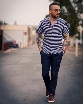 Dark Brown Low Top Sneakers Outfits For Men: This combo of a navy horizontal striped short sleeve shirt and navy chinos is well-executed and yet it's easy and apt for anything. A pair of dark brown low top sneakers will be a stylish complement for this outfit.
