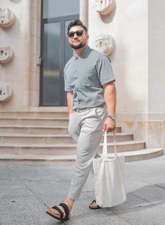 Black Canvas Sandals Outfits For Men: The combination of a grey short sleeve shirt and grey chinos makes for a solid casual menswear style. Black canvas sandals are guaranteed to bring a touch of stylish effortlessness to your ensemble.