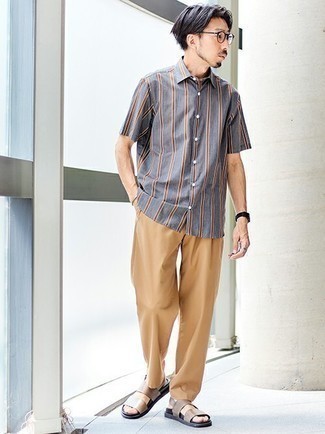 Brown Leather Sandals Outfits For Men: This combo of a grey vertical striped short sleeve shirt and khaki chinos is very versatile and apt for any sort of adventure you may find yourself on. To give your overall ensemble a more casual touch, complement this outfit with brown leather sandals.