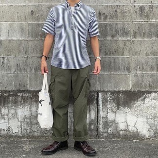 Olive Cargo Pants Outfits: A white and navy vertical striped short sleeve shirt and olive cargo pants are a combo that every sharp gent should have in his casual closet. If you wish to instantly up the style ante of this outfit with one item, introduce burgundy leather derby shoes to your ensemble.