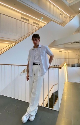 White Crew-neck T-shirt Outfits For Men: Go for a straightforward yet neat and relaxed option teaming a white crew-neck t-shirt and white chinos. Let your expert styling truly shine by rounding off your ensemble with white leather low top sneakers.