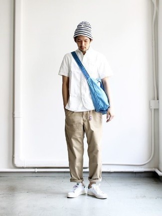 Aquamarine Canvas Messenger Bag Outfits: Wear a white short sleeve shirt with an aquamarine canvas messenger bag if you're after an outfit option that is all about casual cool. Change up this ensemble with a dressier kind of shoes, such as these white leather low top sneakers.