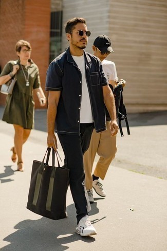 Olive Canvas Tote Bag Outfits For Men: This combo of a navy short sleeve shirt and an olive canvas tote bag is proof that a safe off-duty ensemble doesn't have to be boring. When it comes to shoes, add white athletic shoes to the equation.