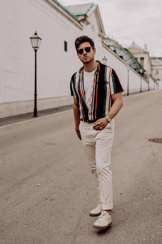 Beige Chinos Casual Outfits: Rock a multi colored vertical striped short sleeve shirt with beige chinos to don a cool and casual ensemble. White leather low top sneakers are a welcome complement to this look.