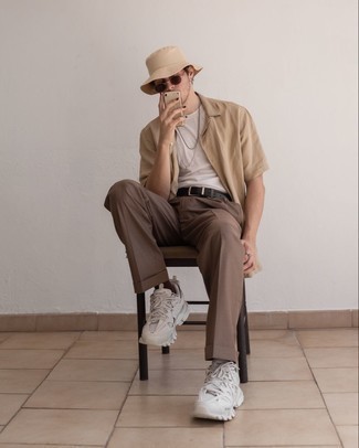 Beige Short Sleeve Shirt Outfits For Men: A beige short sleeve shirt and brown chinos are wonderful menswear must-haves that will integrate well within your day-to-day off-duty repertoire. Serve a little mix-and-match magic by finishing with a pair of white athletic shoes.