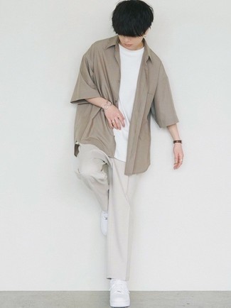 Grey Chinos Outfits: For a relaxed casual ensemble, dress in a tan short sleeve shirt and grey chinos — these two pieces play beautifully together. White leather low top sneakers are a nice choice to round off your look.