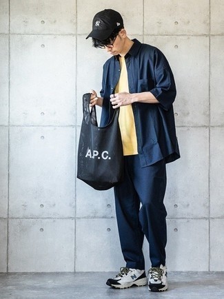Black Canvas Tote Bag Outfits For Men: A navy short sleeve shirt and a black canvas tote bag are a relaxed combo that every sartorial-savvy guy should have in his casual styling repertoire. For maximum impact, complete your ensemble with white and black athletic shoes.