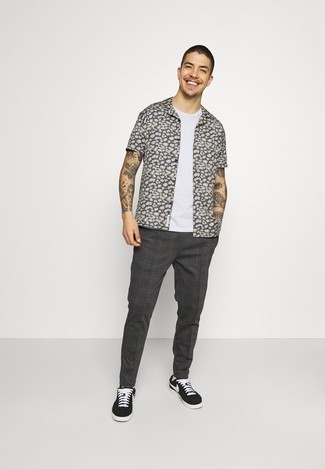 Charcoal Leopard Short Sleeve Shirt Outfits For Men: To don an off-duty outfit with a modern twist, you can rock a charcoal leopard short sleeve shirt and charcoal plaid chinos. This ensemble is complemented perfectly with a pair of black and white canvas low top sneakers.