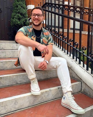 Beige Canvas High Top Sneakers Outfits For Men: Opt for a multi colored camouflage short sleeve shirt and white jeans to achieve an interesting and current laid-back outfit. Unimpressed with this outfit? Introduce a pair of beige canvas high top sneakers to mix things up.
