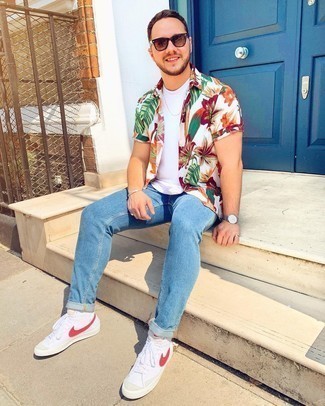 White Floral Short Sleeve Shirt Outfits For Men: Team a white floral short sleeve shirt with blue jeans for a cool and casual and fashionable look. Let your styling expertise really shine by finishing your ensemble with white and red canvas high top sneakers.