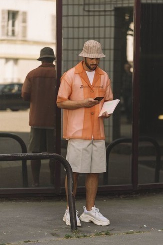 Men's Outfits 2022: For an ensemble that delivers functionality and style, reach for an orange mesh short sleeve shirt.