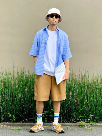 White Bucket Hat Outfits For Men: This pairing of a light blue vertical striped short sleeve shirt and a white bucket hat embodies laid-back attitude and casual menswear style. Complete your look with tan athletic shoes to take things up a notch.