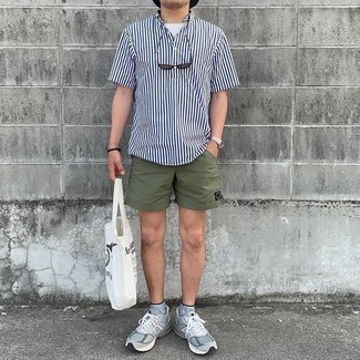 White and Navy Vertical Striped Short Sleeve Shirt Outfits For Men: Extremely stylish, this combo of a white and navy vertical striped short sleeve shirt and olive sports shorts will provide you with amazing styling opportunities. Add grey athletic shoes to the mix for extra fashion points.