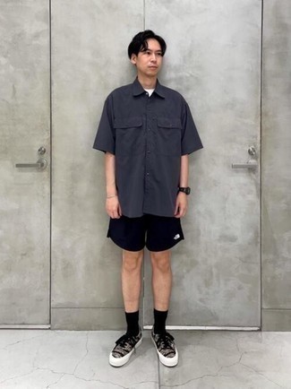 Charcoal Short Sleeve Shirt Outfits For Men: A charcoal short sleeve shirt and black sports shorts are essential in any gentleman's properly balanced casual arsenal. Complete this ensemble with black camouflage canvas low top sneakers to instantly turn up the fashion factor of your ensemble.