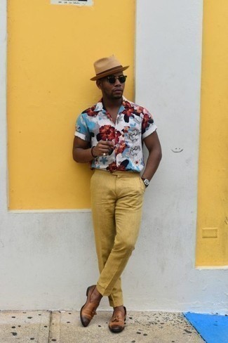 Tan Leather Loafers Outfits For Men: This combination of a white floral short sleeve shirt and mustard dress pants looks considered and immediately makes any guy look stylish. Finishing with a pair of tan leather loafers is a surefire way to infuse an air of sophistication into this look.