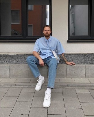 White Leather Low Top Sneakers Outfits For Men: This casually stylish look is really pared down: a light blue short sleeve shirt and light blue jeans. White leather low top sneakers make your look whole.