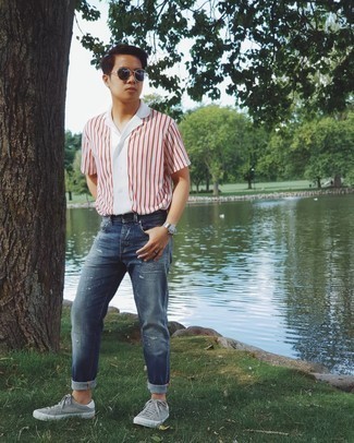 Navy Sunglasses Outfits For Men: A white and red vertical striped short sleeve shirt and navy sunglasses are indispensable essentials if you're figuring out a casual wardrobe that matches up to the highest sartorial standards. Grey canvas low top sneakers will effortlessly class up even the most basic of outfits.