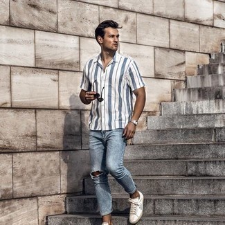 White Vertical Striped Short Sleeve Shirt Outfits For Men: Look dapper without exerting much effort by opting for a white vertical striped short sleeve shirt and light blue ripped jeans. To bring a little flair to your look, complement your getup with a pair of white and black print canvas low top sneakers.