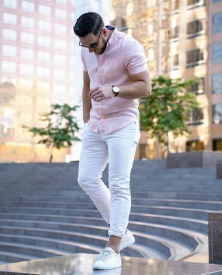 Pink Short Sleeve Shirt Outfits For Men: Wear a pink short sleeve shirt with white jeans if you seek to look casual and cool without much effort. Complete your outfit with white leather low top sneakers for extra style points.