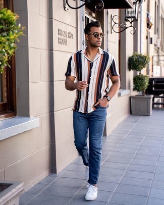Men's Multi colored Vertical Striped Short Sleeve Shirt, Navy Jeans, White Canvas Low Top Sneakers, Dark Brown Sunglasses