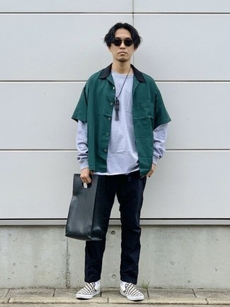 Black and White Leather Tote Bag Outfits For Men: Go for a pared down yet casually stylish option by teaming a dark green short sleeve shirt and a black and white leather tote bag. A pair of black and white check canvas slip-on sneakers effortlessly ups the wow factor of this look.