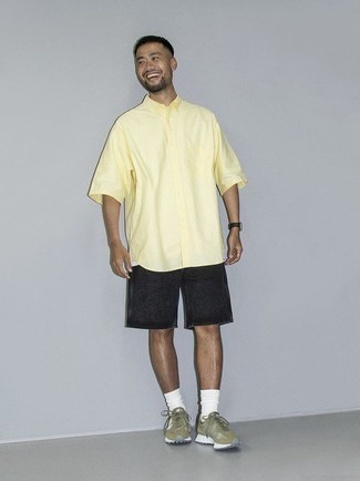 Denim Shorts Outfits For Men: Dial it down for the day in this comfortable pairing of a yellow short sleeve shirt and denim shorts. Complement your getup with a pair of olive athletic shoes to keep the look fresh.