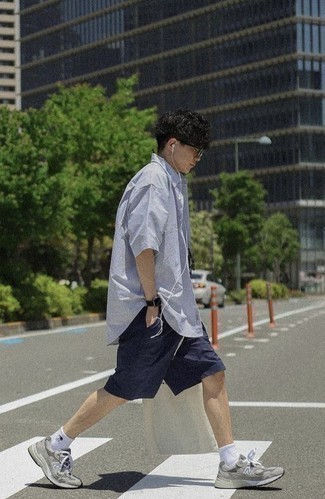 Men's Outfits 2022: Demonstrate your chops in men's fashion by teaming a light blue vertical striped short sleeve shirt and navy shorts for an off-duty ensemble. Give an easy-going feel to this ensemble by sporting grey athletic shoes.