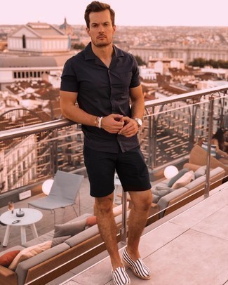Black Short Sleeve Shirt Outfits For Men: Go for a pared down but casually dapper choice in a black short sleeve shirt and black shorts. A pair of white and black horizontal striped canvas espadrilles will tie the whole thing together.