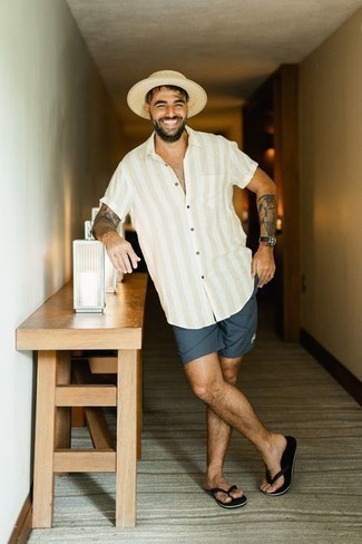 Flip Flops Outfits For Men: Perfect the cool and casual look in a beige vertical striped short sleeve shirt and navy shorts. Flip flops will add a more casual spin to an otherwise all-too-safe look.