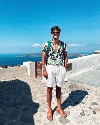 1200+ Relaxed Outfits For Men: Demonstrate your chops in menswear styling by putting together a white floral short sleeve shirt and white linen shorts for a casual combo. Add tobacco leather flip flops to the mix to loosen things up.