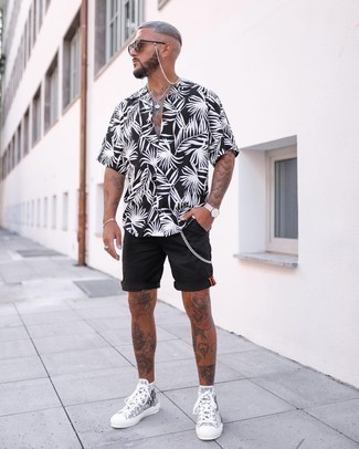 Grey Canvas High Top Sneakers Outfits For Men: This combination of a black and white print short sleeve shirt and black shorts is a great look for when it's time to clock off. Complement your outfit with a pair of grey canvas high top sneakers to immediately up the style factor of this outfit.