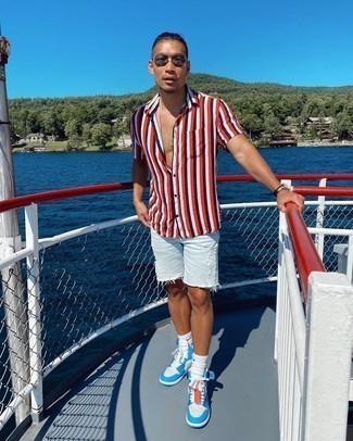 White and Blue Leather High Top Sneakers Outfits For Men: Opt for a multi colored vertical striped short sleeve shirt and white ripped denim shorts for an easy-to-create ensemble. On the footwear front, this outfit is finished off nicely with white and blue leather high top sneakers.