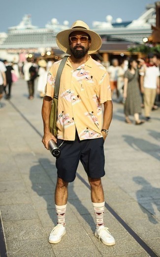 Men's Yellow Print Short Sleeve Shirt, Navy Shorts, White Canvas Low Top Sneakers, Olive Canvas Messenger Bag