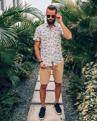 White and Black Print Short Sleeve Shirt Outfits For Men: Consider pairing a white and black print short sleeve shirt with tan shorts for a stylish, casual outfit. Complement your getup with a pair of navy canvas low top sneakers and you're all set looking awesome.
