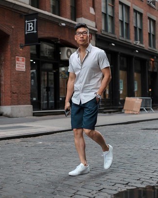 White Short Sleeve Shirt Outfits For Men: Rock a white short sleeve shirt with navy shorts for a cool and casual and fashionable look. If in doubt as to the footwear, add a pair of white canvas low top sneakers to the mix.