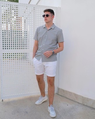 White Leather Low Top Sneakers Outfits For Men: A white and black vertical striped short sleeve shirt and white shorts matched together are a match made in heaven for those who prefer off-duty styles. Complement this outfit with white leather low top sneakers and you're all done and looking boss.