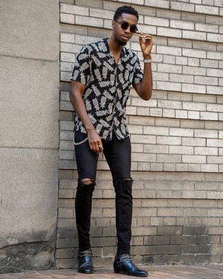 Black Embellished Leather Chelsea Boots Outfits For Men: This casual combo of a black and white print short sleeve shirt and black ripped skinny jeans is a winning option when you need to look cool but have no time to dress up. Serve a little outfit-mixing magic by finishing with a pair of black embellished leather chelsea boots.