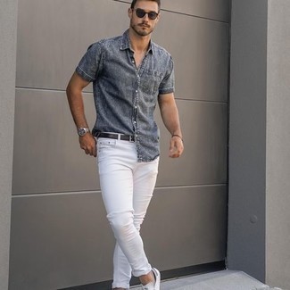 Charcoal Denim Short Sleeve Shirt Outfits For Men: This casual combination of a charcoal denim short sleeve shirt and white skinny jeans is a safe option when you need to look stylish but have no extra time to dress up. Complete your getup with a pair of white and navy canvas low top sneakers et voila, this outfit is complete.