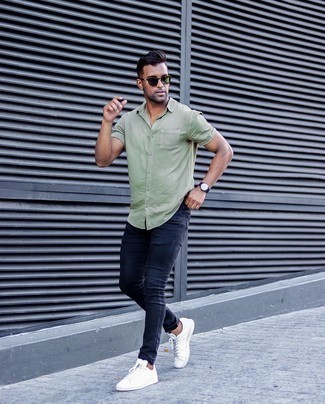 Navy Skinny Jeans Casual Outfits For Men: We all look for functionality when it comes to fashion, and this city casual pairing of an olive short sleeve shirt and navy skinny jeans is a perfect example of that. Look at how nice this look goes with a pair of white leather low top sneakers.