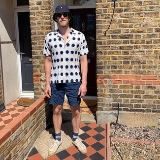 Sunglasses Outfits For Men: A white polka dot short sleeve shirt and sunglasses married together are a sartorial dream for those dressers who love laid-back styles. Beige canvas low top sneakers will effortlessly elevate even the simplest ensemble.