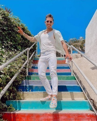 White Canvas Slip-on Sneakers Outfits For Men: Consider teaming a grey print short sleeve shirt with white jeans to feel invincible and look casually cool. A pair of white canvas slip-on sneakers is a safe footwear style here that's full of character.