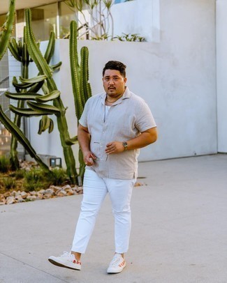 White Tank Outfits For Men: When the setting allows an off-duty look, try teaming a white tank with white ripped jeans. Infuse your look with a hint of sophistication by rounding off with white print canvas low top sneakers.