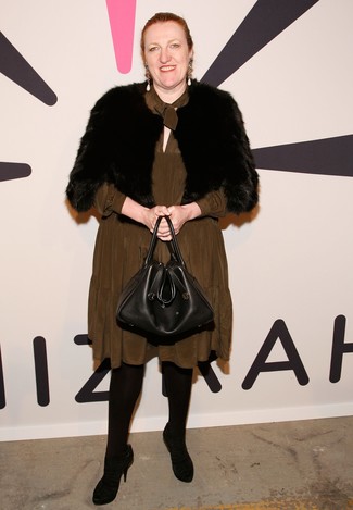 Glenda Bailey wearing Black Fur Shrug, Olive Silk Midi Dress, Black Suede Pumps, Black Leather Tote Bag