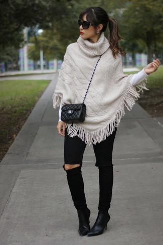 Women's Black Suede Ankle Boots, Black Ripped Skinny Jeans, White Crew-neck Sweater, Beige Knit Poncho