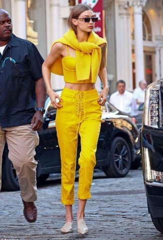 Gigi Hadid wearing Beige Leather Mules, Yellow Skinny Pants, Yellow Cropped Top, Yellow Oversized Sweater