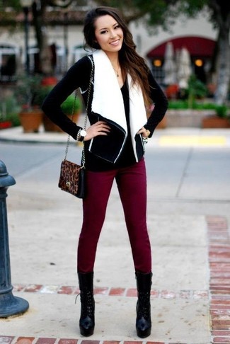 Women's Black Chunky Leather Lace-up Ankle Boots, Burgundy Skinny Pants, Black V-neck Sweater, Black and White Shearling Vest