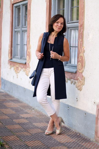Tan Leather Pumps Outfits After 50: This pairing of a navy sleeveless coat and white capri pants is a safe and very stylish bet. Our favorite of a myriad of ways to complement this outfit is tan leather pumps.